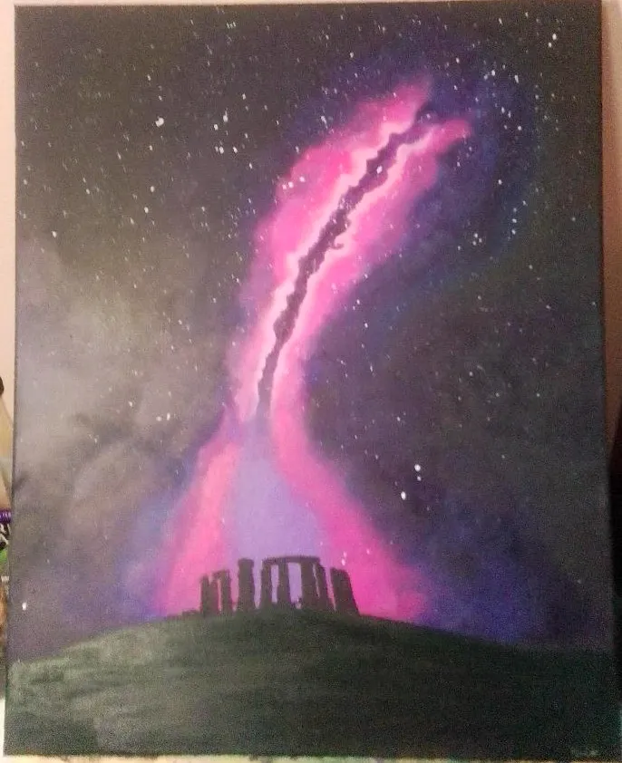Untitled. A pink and violet aurora streams over Stonehenge silhouetted on a dark hill.